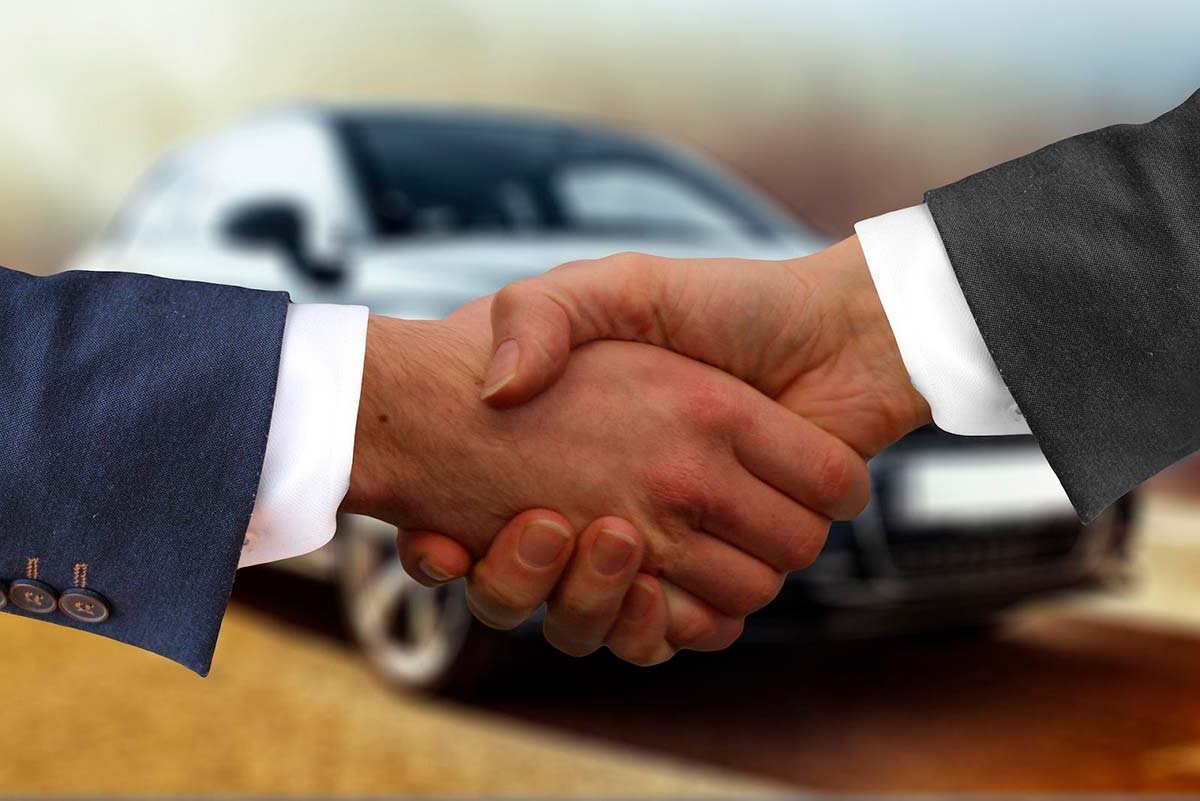 Skakar hand efter ett lyckat bilköp